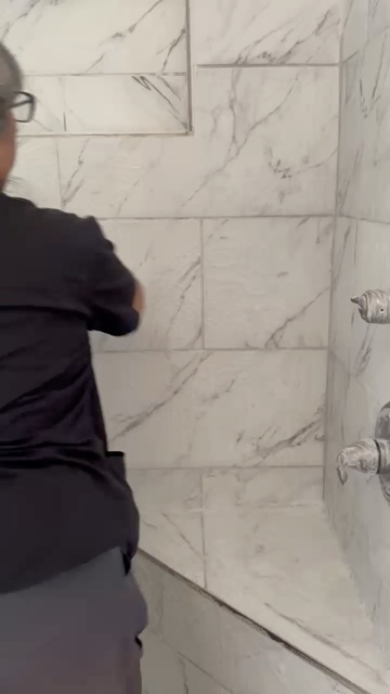 JNJ team detailing marble shower wall